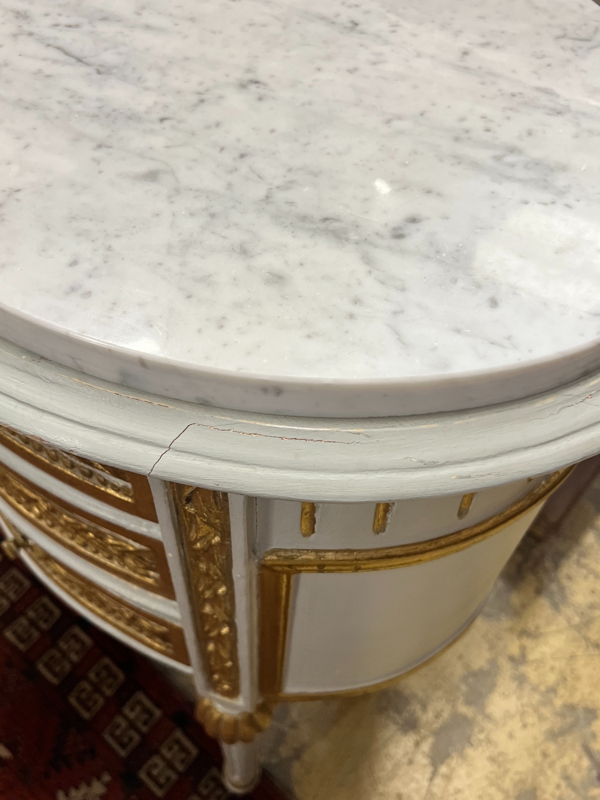 A pair of oval French marble topped bedside cabinets, width 51cm, depth 48cm, height 70cm